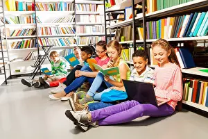 Pupils Prints: Children sitting on floor in library and studying