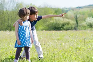 Sisters Prints: Children standing in field together, looking at something in the distance