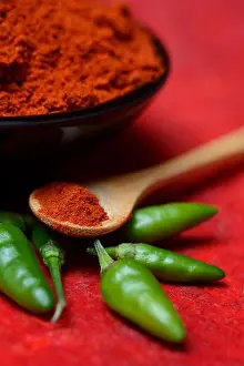 Color Images Prints: Chili powder in bowl, green pepper (Capsicum annuum)