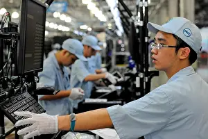 Chengdu Prints: Chinese workers assemble desktop computers on the production line at the global operations site of Dell in Chengdu city