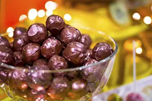 Tempting Prints: Chocolate bonbons wrapped in purple foil in a glass bowl