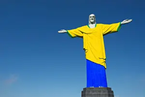 Cristo Prints: Christ the Redeemer wearing Brazil colors football soccer uniform at Corcovado Rio de Janeiro