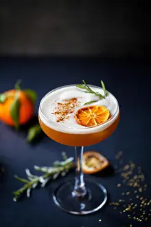 Clementine Prints: Christmas cocktail of amaretto sour with dehydrated clementine and rosemary