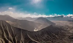 Landscape Park Prints: Cinematic shot aerial view of Mount Bromo crater with active volcano smoke in East Java