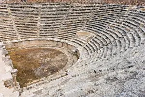 Stable Prints: Circular stone seating in a well preserved Greek amphitheatre viewed looking down from the top to the arena