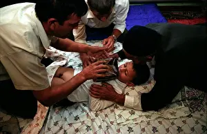Circumcision Prints: The circumcision master and the closest male relatives of the boy gather near the bed for a prayer