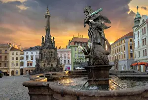 Hercules Prints: Cityscape of main square with Hercules fountain and monument Holy Trinity Column at sunset sunlight