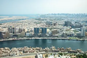 Deira Prints: Cityscape view of Deira and Old Dubai area behind man-made Dubai Canal. Dubai, UAE