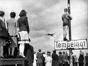 Civilians Prints: Civilians watching an airlift plane land during the Berlin Blockade, 1948