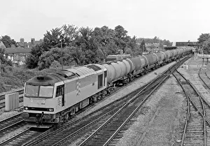 Loco Prints: A Class 60 diesel locomotive number 60064 heads south with a lengthy train of bogie oil tanks at Oxford on the 2nd July