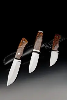Ergonomic Prints: Classic hunting knives with wooden handles. Hunting edged weapons on a dark background