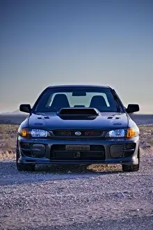 Turbo Prints: A Classic Subaru Impreza turbo custom car with blue sky and desert landscape