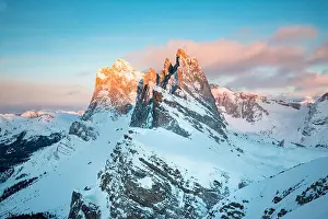Classic view of famous Seceda mountain peaks in the Dolomites illuminated in beautiful evening light at sunset in winter, South Tyrol, Italy