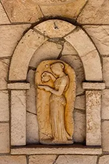 a classical greek stone plaque or sculpture inset into a wall on the greek island of zakynthos, zante, greece