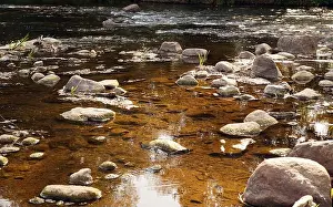 Boulders Prints: Clean natural river. Fast current in the stony riverbed