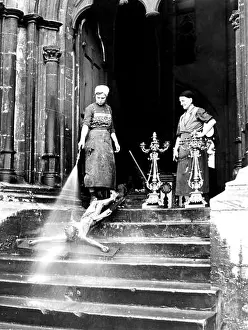 Spray Prints: Two cleaning ladies spray crucifix with Jesus, ca. 1920, around Leipzig, Germany