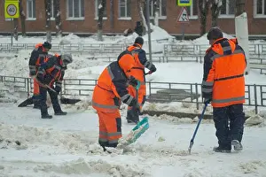 Snowstorm Prints: Cleans snow with a shovel. Workers are cleaning the roads after a snowfall
