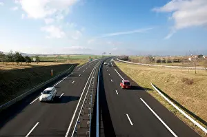 Rural Area Prints: Clear highway stretch with vehicles navigating through rural landscape on a sunny day