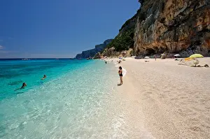 Sardinia Prints: Clear and transparent sea waters with tourists at Cala dei Gabbiani beach