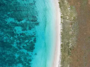 Clear, warm water bathes a remote beach in Komodo National Park, Indonesia. This part of the Lesser Sunda Islands is home to high biodiversity