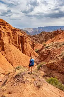Mountainscape Prints: Climber in a canyon with a dry stream bed