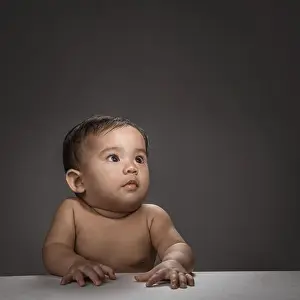 Cuteness Prints: close up of baby face look up thinking over grey background