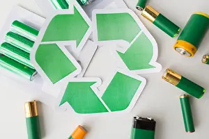 Dump Prints: close up of batteries and green recycling symbol