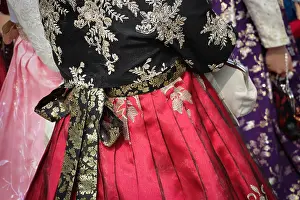Purse Prints: Close up of a bright red pleated chima or wrap-around skirt