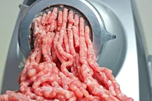 Grinder Prints: close up of freshly ground pork minced in an electric meat grinder