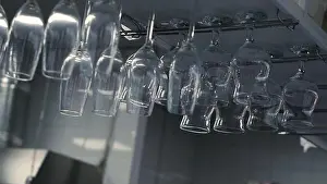 Rack Prints: Close up of glasses hanging upside down at the kitchen restaurant