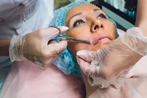 Headband Prints: Close up of a hands threading beautiful womans upper lip