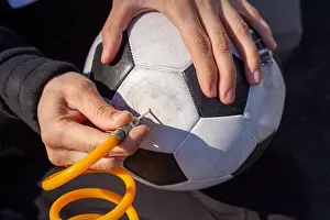 Tubing Prints: Close up image showing a caucasian woman holding a soccer ball