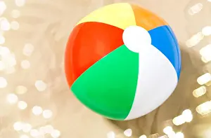 Inflatable Prints: close up of inflatable beach ball on sand
