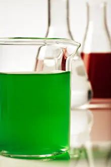 Biotechnology Prints: close up detail of laboratory beakers with different coloured liquid in them