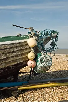 Stern Prints: Close up Old wooden fishing boat on Dungeness beach. Flaking paint