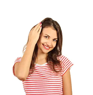 Sensuality Prints: Close up picture of a young beautiful woman fixing her hair while looking at the camera