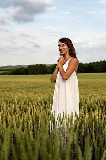 Barley Prints: Close up portrait of happy young brunette woman in white dress on