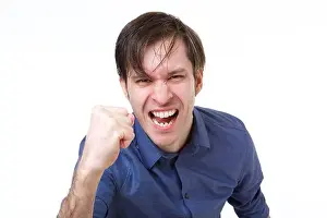 Intense Prints: Close up portrait of man shaking fist in emotional gesture