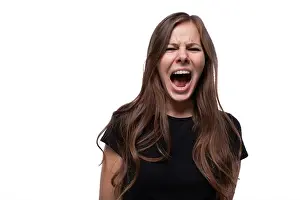 Worry Prints: Close up portrait of young woman screaming and feeling fear