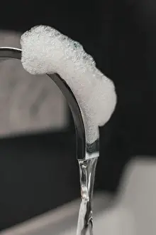 Faucet Prints: close up shot of bathtub tap covered by foam