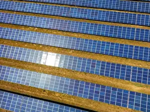 Solar Panels Prints: Close up of a solar power plant generating solar electricity over many rows of solar panels on a sunny day