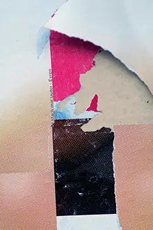 Flaking Prints: The close-up of a billboard with torn-off scraps of paper from abstract psychedelic posters and billboards