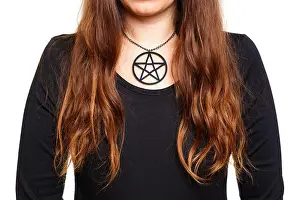 Unrecognizable Prints: Close-up of a brown hair woman wearing a large pentagram pendant isolated on white