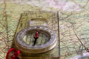 Compass Prints: Close-up of compass on old map with arrow pointing due north