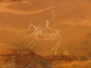 Evidence Prints: Close-up of faded petroglyph of a rider on a horse
