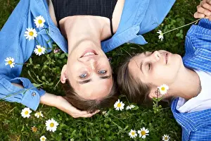 Overhead View Prints: Close-up of female friends relaxing on grassy land in garden