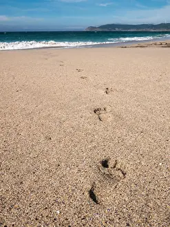 Barefoot Prints: Close-up of footprints in the sand on the beach of Praia do Rostro in Galicia