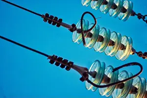 Construction Equipment Prints: Close-up of glass power insulators with high woltage wires