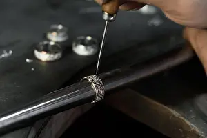 Craftsman Prints: Close-up of hand of a goldsmith setting the diamond on the ring