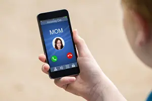 Phone Call Prints: Close-up Of A Hand Holding Smart Phone With Mom's Incoming Call On Display